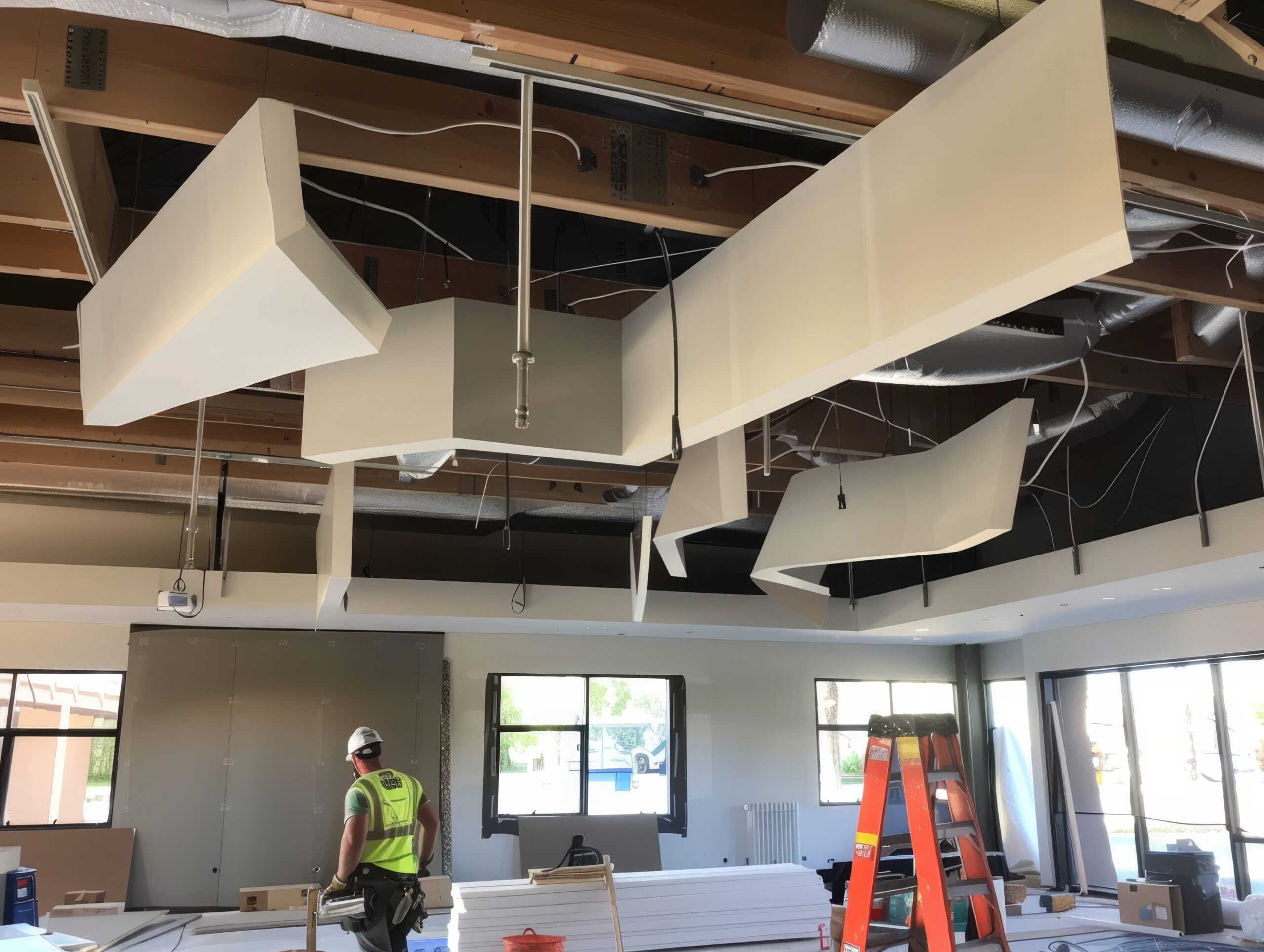 Professional technicians installing acoustic panels on ceiling in photography shot